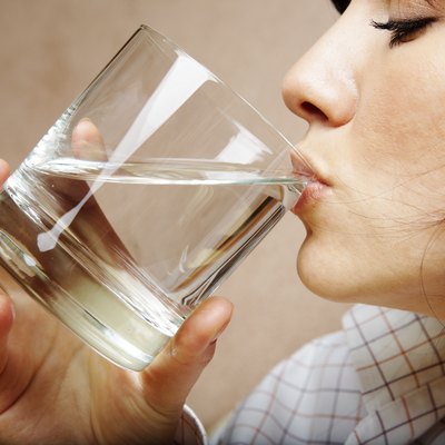 young woman with glass of mineral water