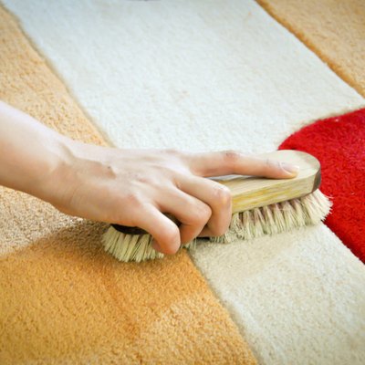 woman cleaning carpet from stain