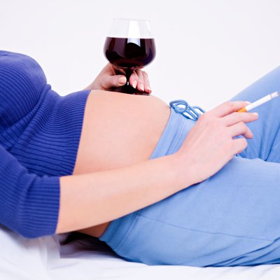 Pregnant woman with a glass of wine