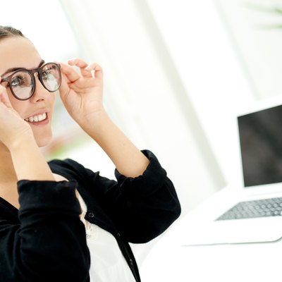 Young businesswoman adjusting her glasses