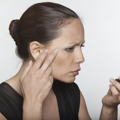 beautiful asian woman aging looking in the mirror