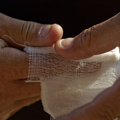 White medicine bandage on human injury hand finger