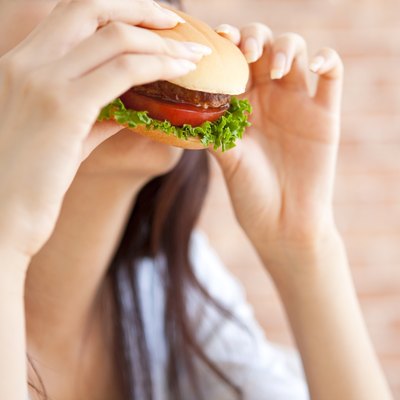 Young woman eating a hamburger