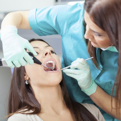 Young woman patient and dentist