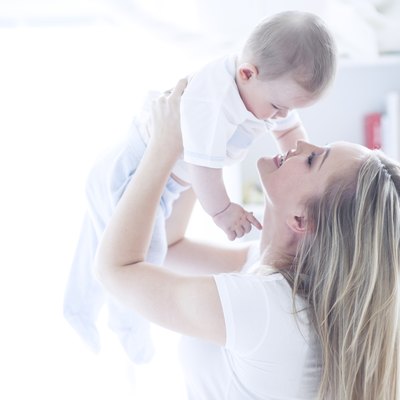Teenage girl holding baby boy