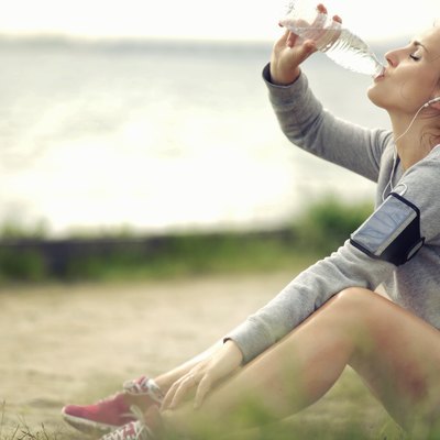Female Runner Drinking Water