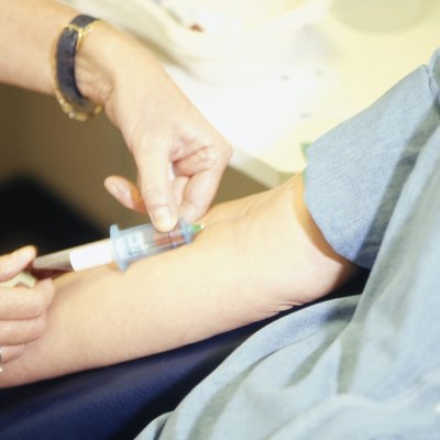 Woman having blood taken, close-up of hands