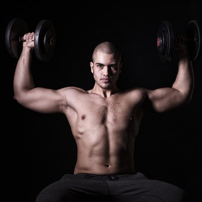 Muscular men exercising with weights