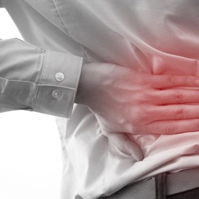 Man in office uniform having back pain issue / back injury