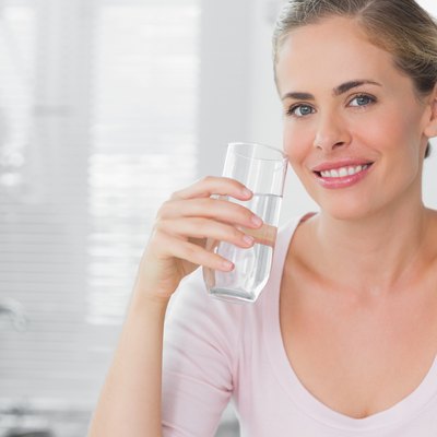 Woman holding glass of water