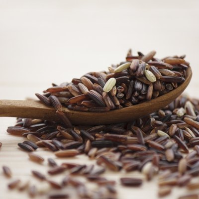 brown rice and wooden spoon