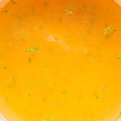 Closeup of broth, clear soup or bouillon in a saucepan