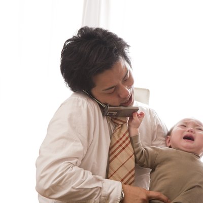 Baby Girl Pulling Cellular Phone from Father