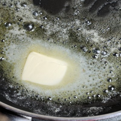 Piece of butter melting on non-stick pan