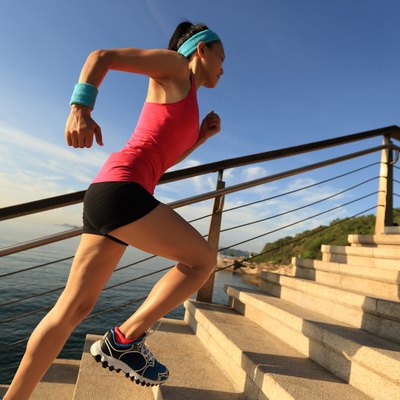 healthy lifestyle sports woman running up on stone stairs seaside