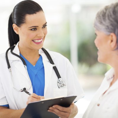 pretty young nurse talking to senior patient
