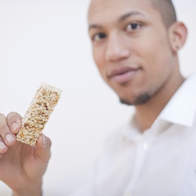 Young African-American Man Eating Cereal Bar