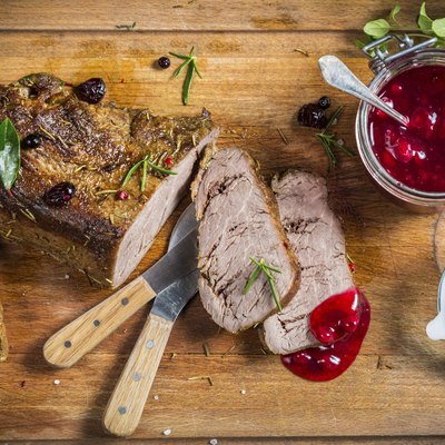 Freshly served venison with cranberries and rosemary