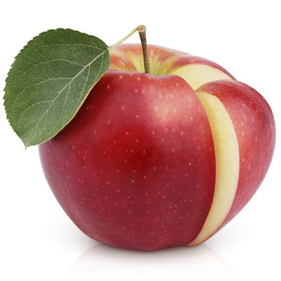 Red apple with green leaf and cut isolated on white