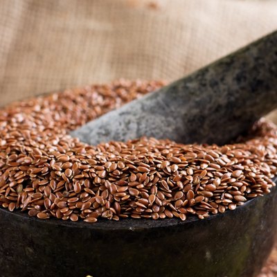 Marble stone mortar full of flax seeds