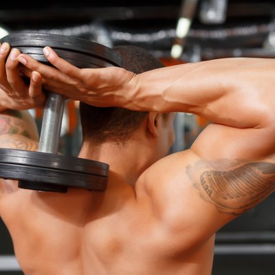 Man holding dumbbells behind his head
