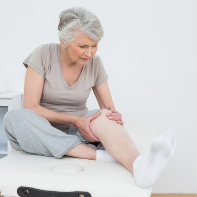 Senior woman with her hands on a painful knee