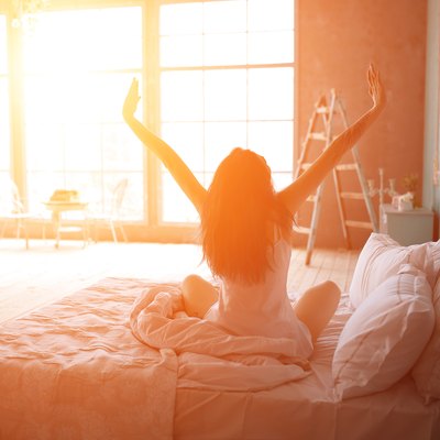 Woman stretching in bed after wake up