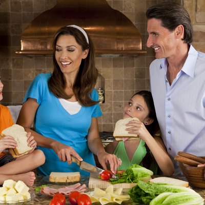 Attractive Family In Kitchen Making Healthy Sandwiches