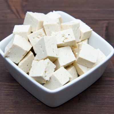 Cubes of tofu square bowl on wood
