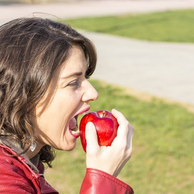 Woman biting an apple