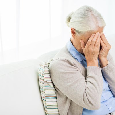 senior woman suffering from headache or grief