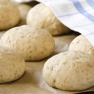 Oat bread buns on a baking sheet