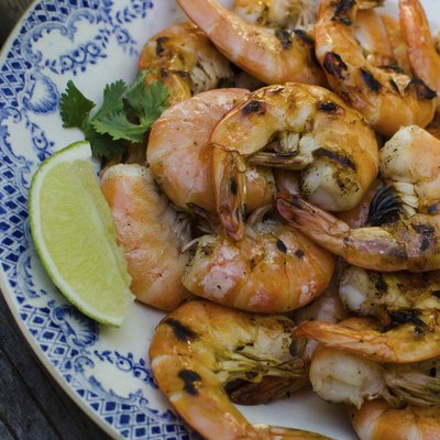 Freshly grilled shrimp on a plate with lime slice