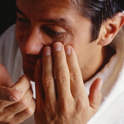 Man inserting contact lenses, close-up