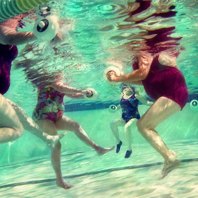 Mature women doing aqua aerobics, uderwater view (Digital Composite)