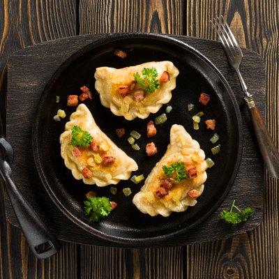 Fried dumplings with onion and bacon top view