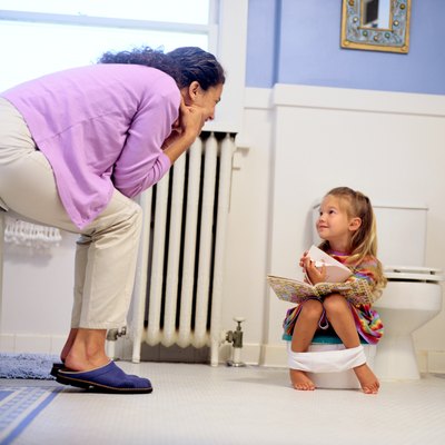Girl Reading a Book on a Potty Chair