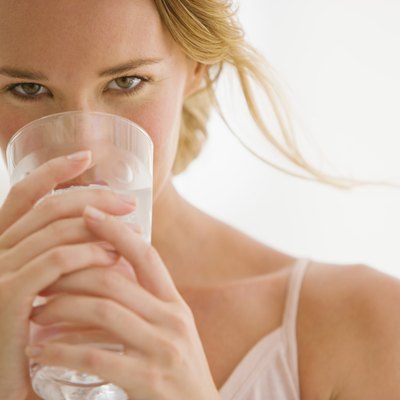 Woman holding glass of water