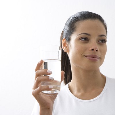 Young woman holding glass of water