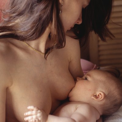 Young mother breastfeeding baby (6-9 months)