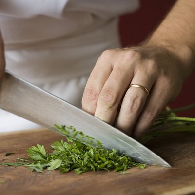Chef chopping parsley