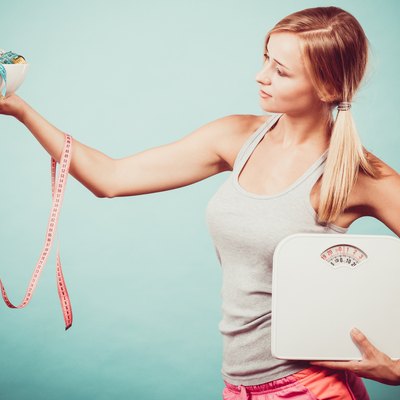 Girl with scales measuring tapes. Weight loss.