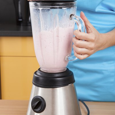 Woman Making Strawberry Milkshake