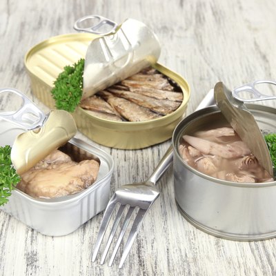 Open tin can, on wooden background