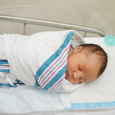 Sleeping Newborn Infant in Hospital Bassinet
