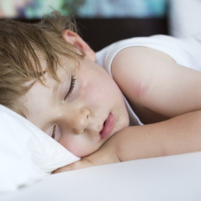 Little sweet toddler boy sleeping in his bed
