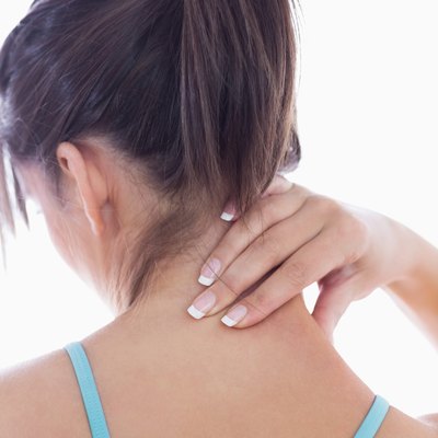 Rear view of young woman with neck pain
