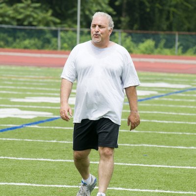 middle age man exercising on sports field
