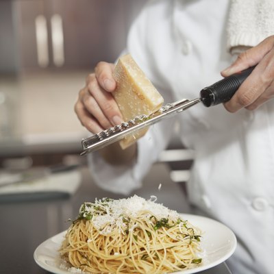 Grating parmesan onto spaghetti