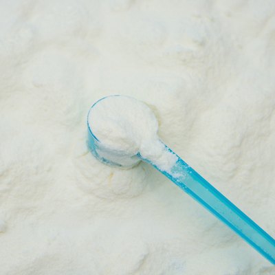 powdered milk in a blue spoon